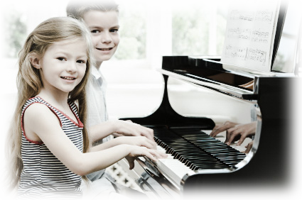 Two happy children playing on the piano